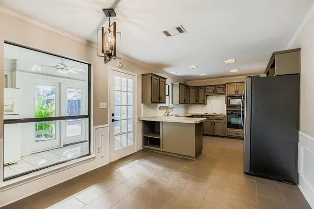 a bathroom with a granite countertop toilet sink and mirror