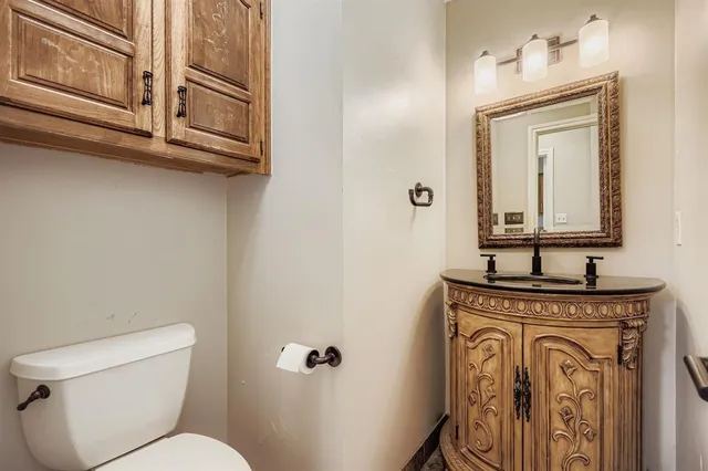 an empty room with chandelier fan and windows