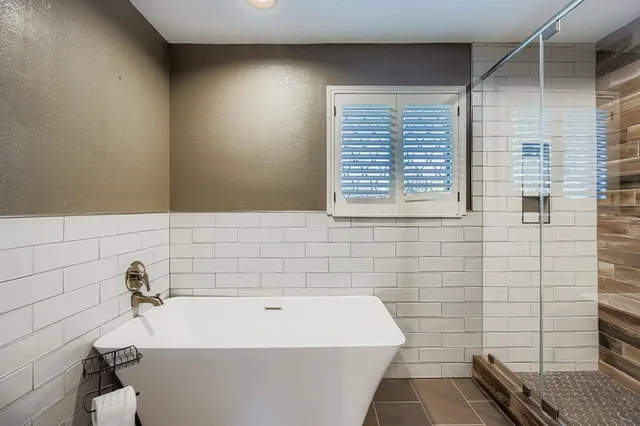 an empty room with a ceiling fan and a window