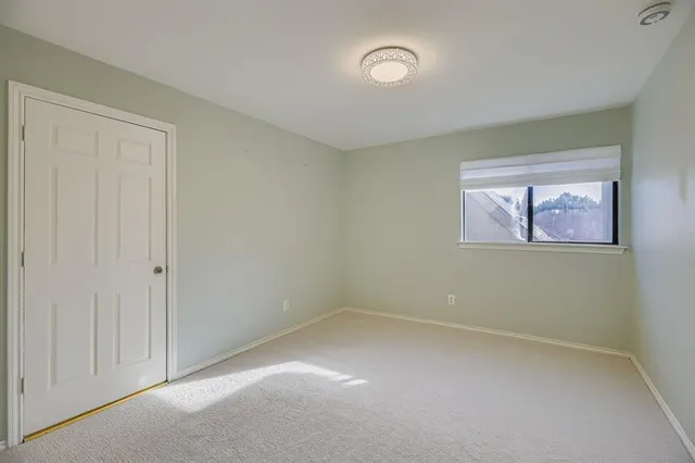 a bathroom with a granite countertop sink a toilet a mirror and shower