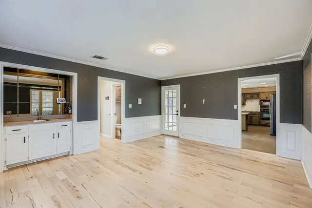a spacious bathroom with a granite countertop sink and mirror