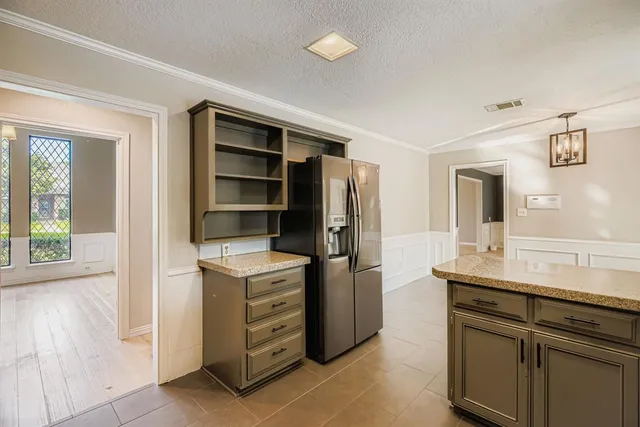 a kitchen with a stove and a refrigerator