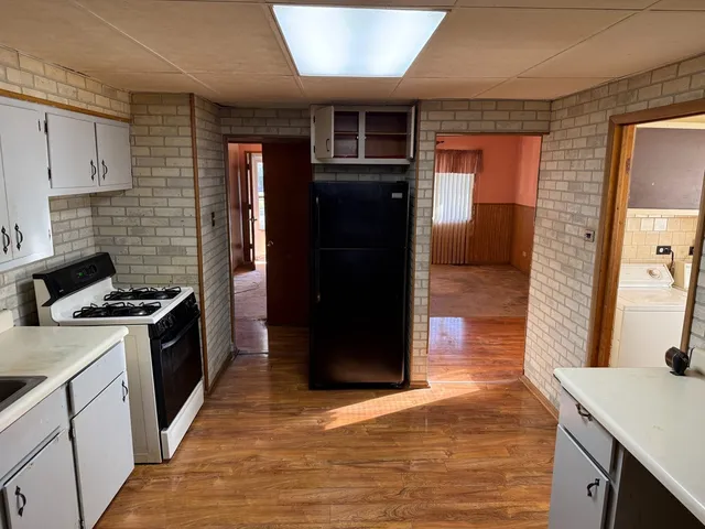 a kitchen with stainless steel appliances granite countertop a stove and a refrigerator