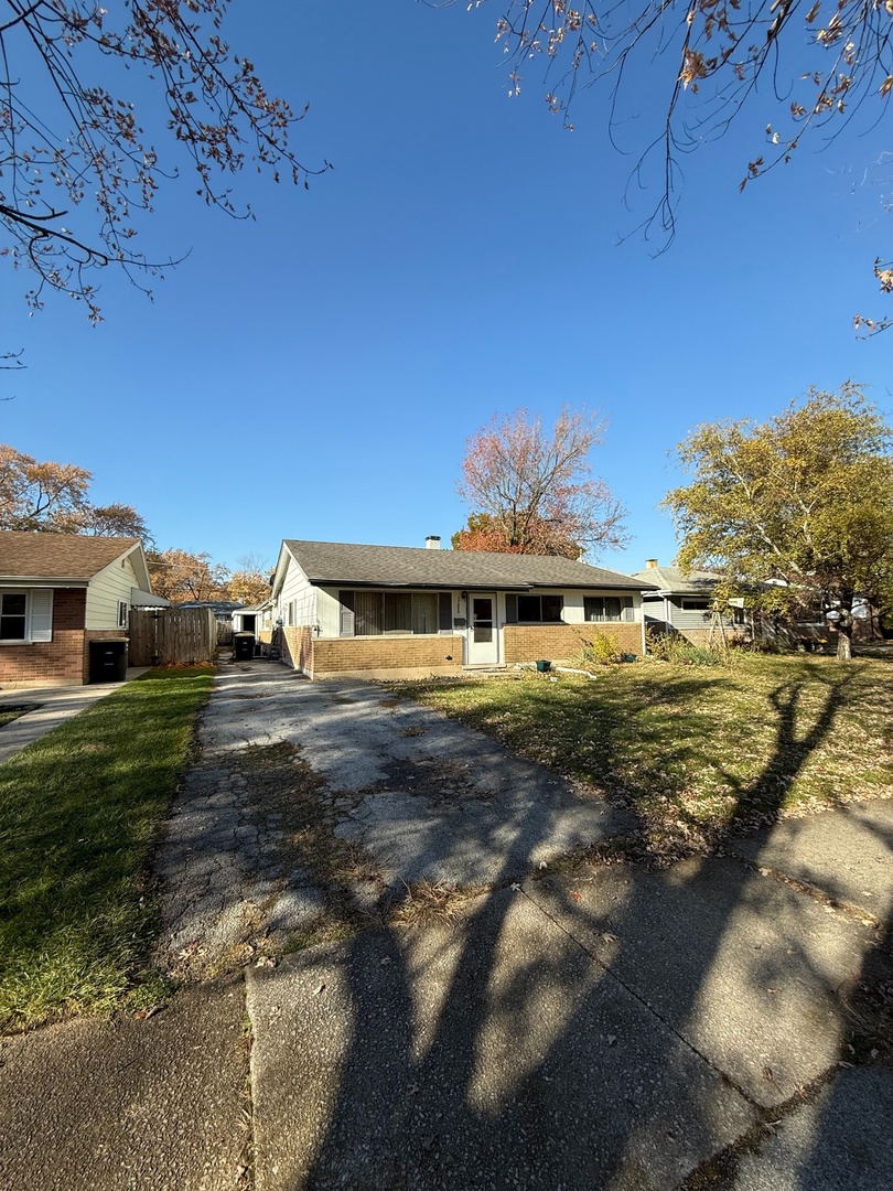 17226 Community Street Lansing, IL 60438 - Photo 2 of 25 a front view of a house with a yard