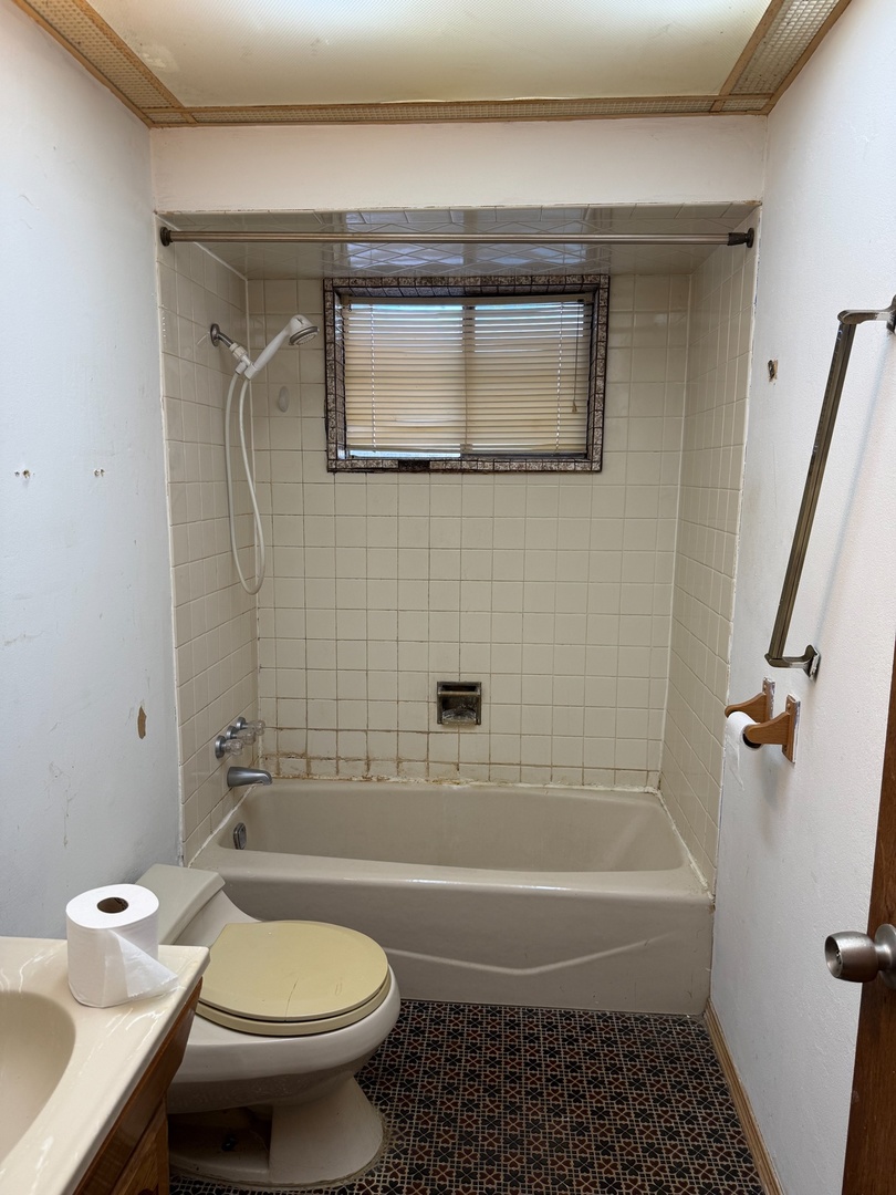 17226 Community Street Lansing, IL 60438 - Photo 6 of 25 a bathroom with a toilet and a bathtub