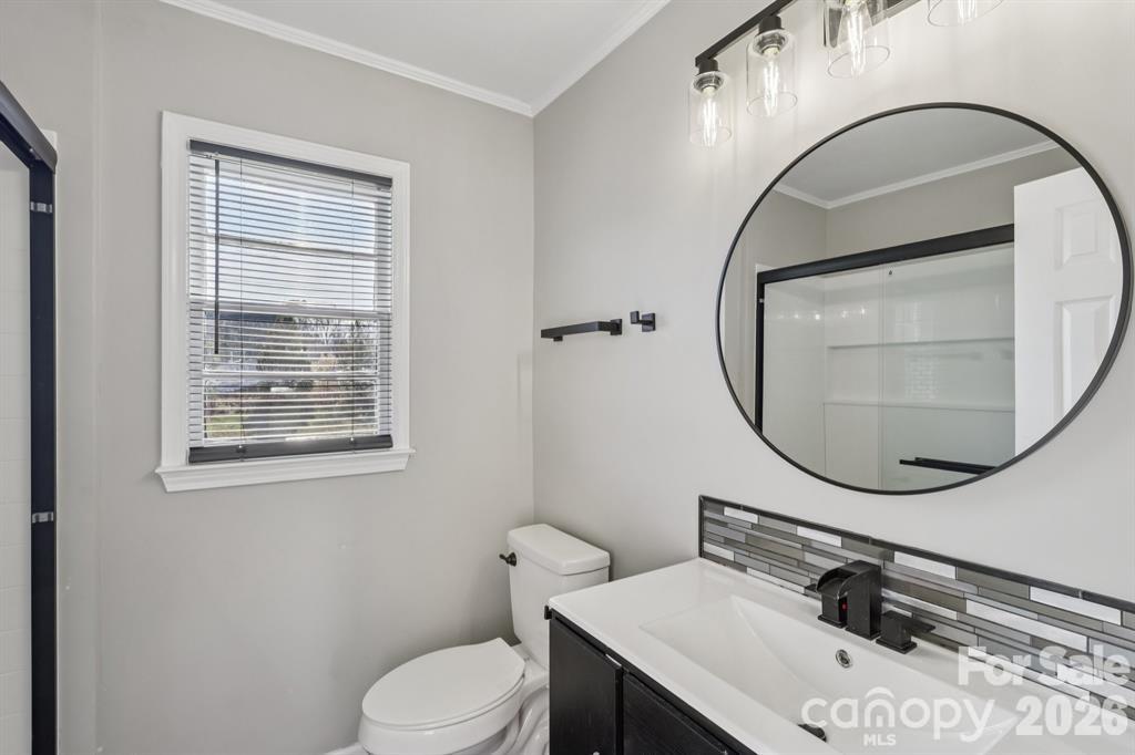 3207 Valley Dale Road Monroe, NC 28110 - Photo 17 of 27 a bathroom with a sink a mirror and a toilet