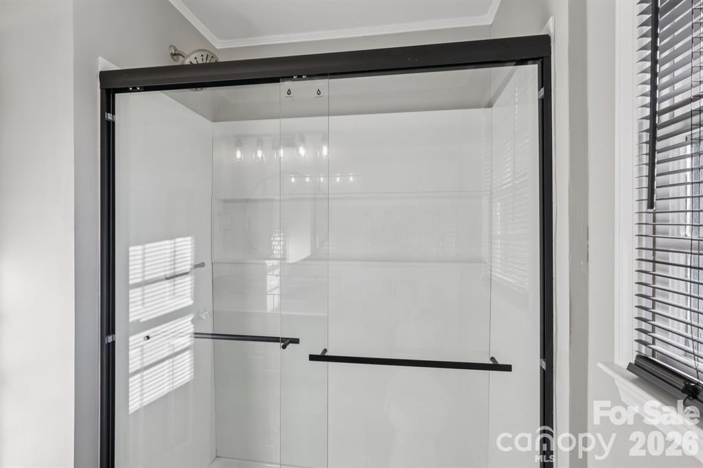 3207 Valley Dale Road Monroe, NC 28110 - Photo 18 of 27 a bathroom with a glass shower door