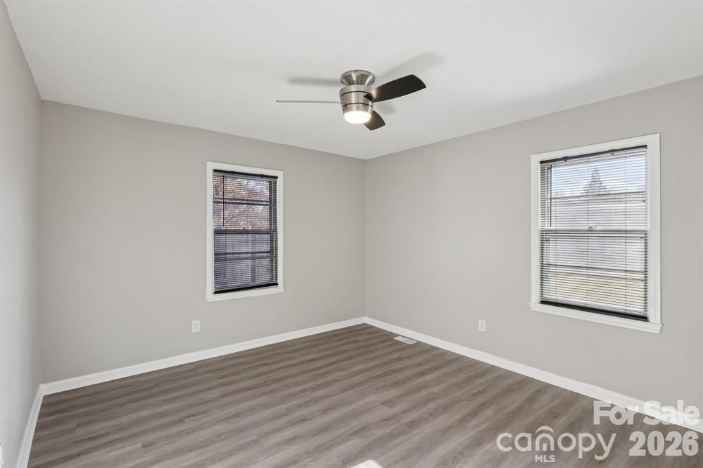 3207 Valley Dale Road Monroe, NC 28110 - Photo 19 of 27 a view of an empty room with a window and wooden floor