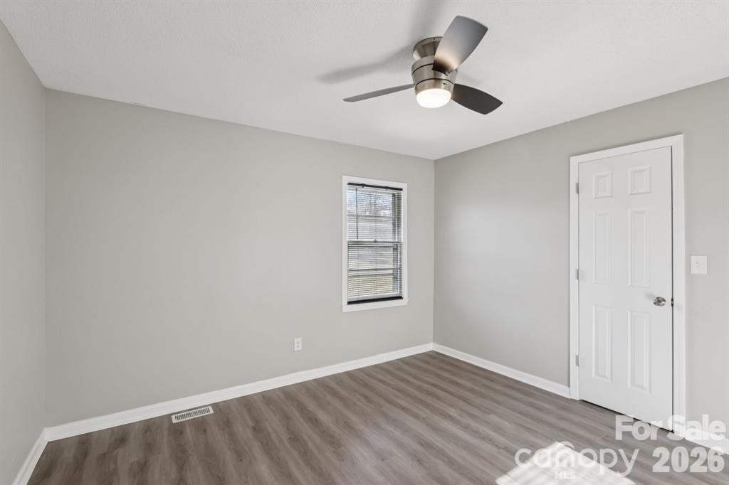 3207 Valley Dale Road Monroe, NC 28110 - Photo 20 of 27 wooden floor in an empty room with a window
