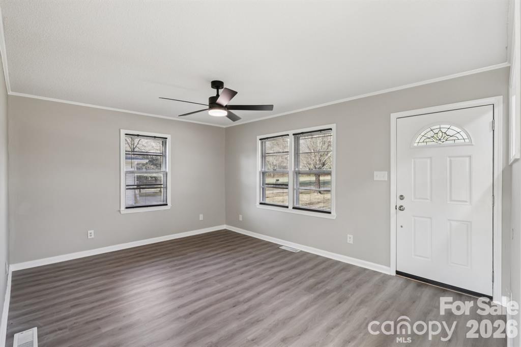 3207 Valley Dale Road Monroe, NC 28110 - Photo 5 of 27 a view of an empty room with a window and wooden floor