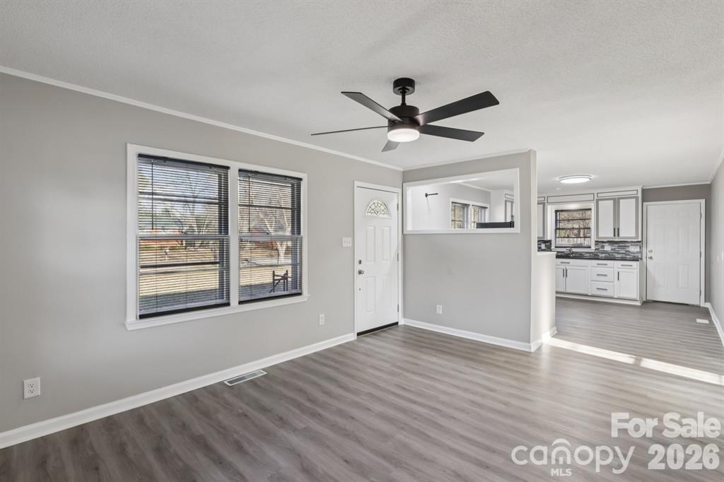 3207 Valley Dale Road Monroe, NC 28110 - Photo 6 of 27 a view of a big room with wooden floor and windows
