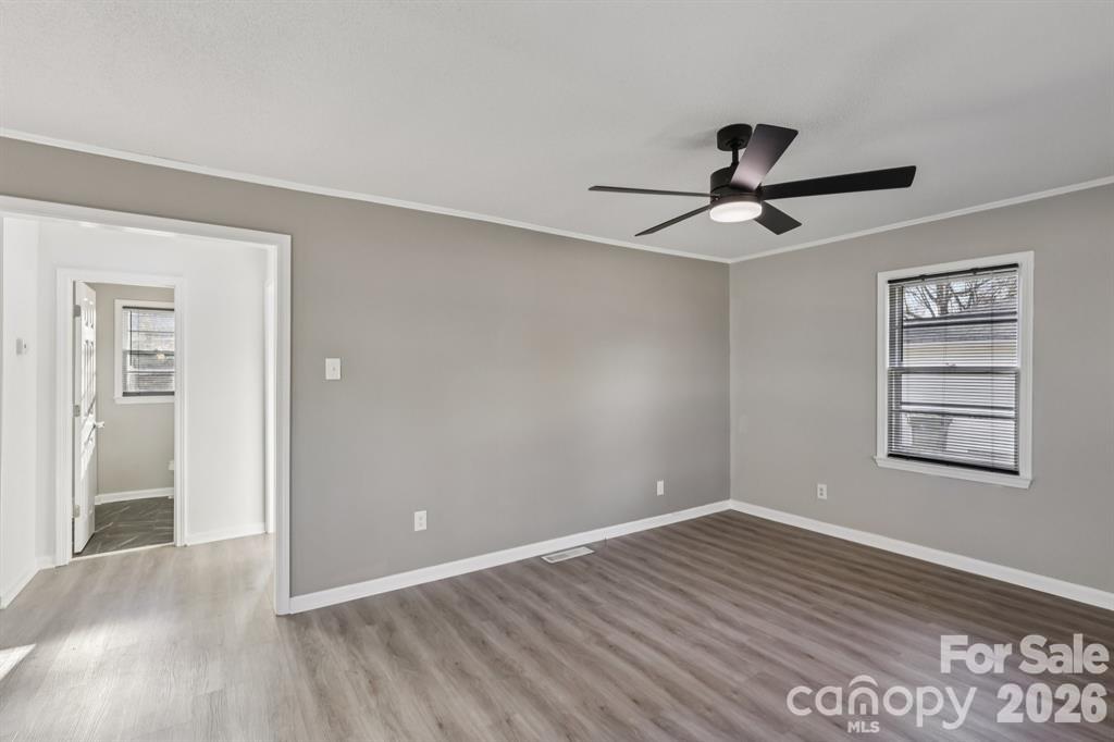 3207 Valley Dale Road Monroe, NC 28110 - Photo 7 of 27 a view of empty room with wooden floor and fan