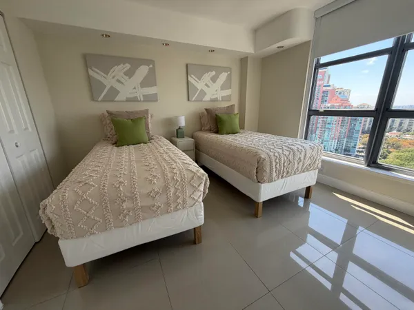 a bedroom with a bed and a painting on the wall