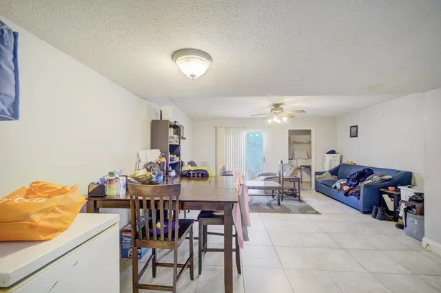 a living room with furniture and a dining table