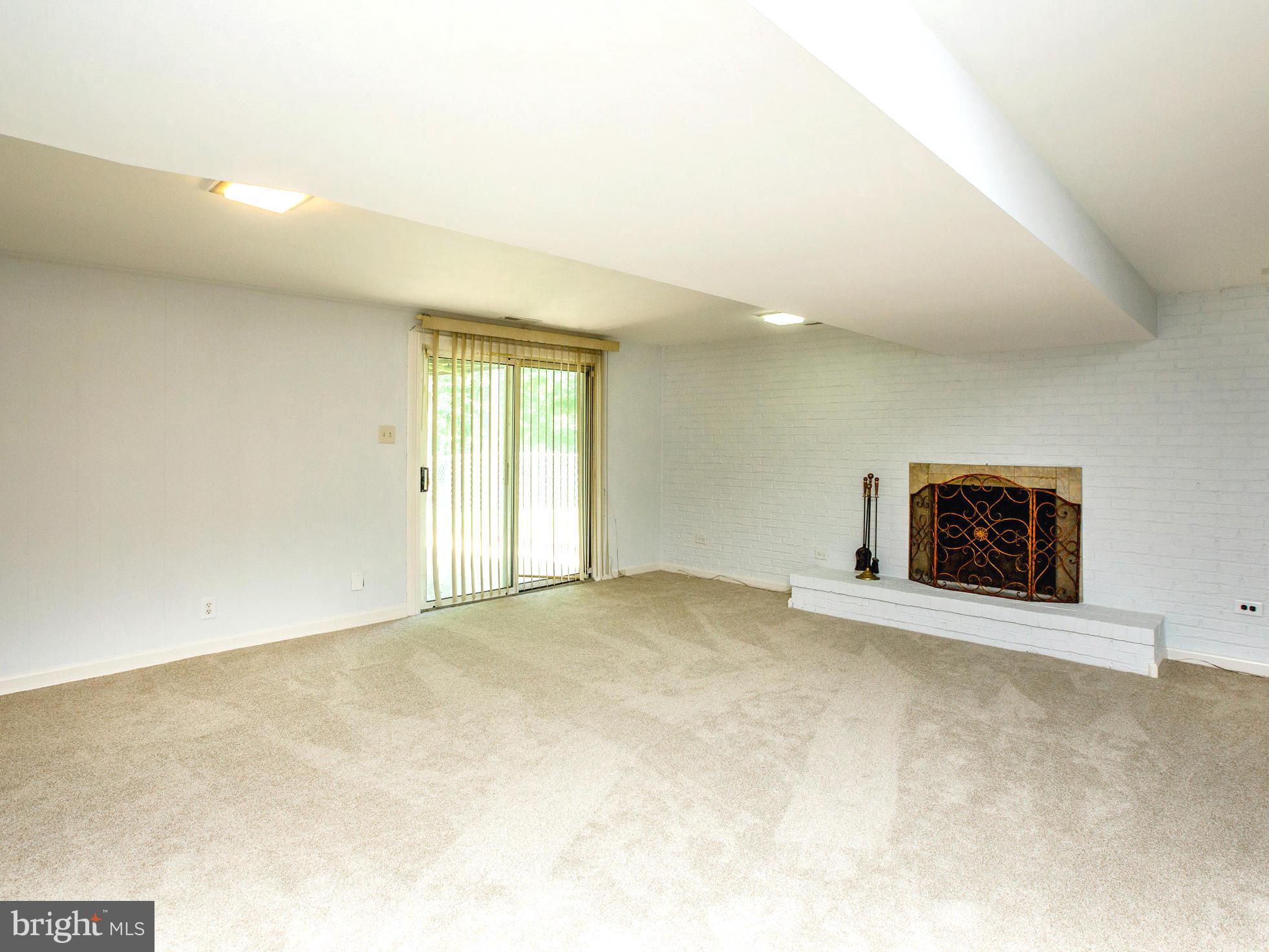 7312 Kathydale Road Pikesville, MD 21207 - Photo 21 of 30 Large lower family room with fireplace
