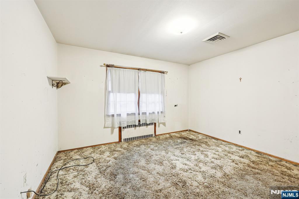 84 Squaw Brook Road North Haledon, NJ 07508 - Photo 13 of 23 an empty room with a empty space and a window
