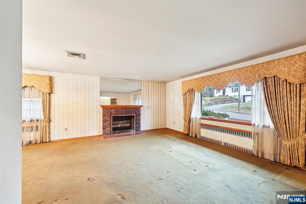 84 Squaw Brook Road North Haledon, NJ 07508 - Photo 3 of 23 an empty room with furniture and a fireplace