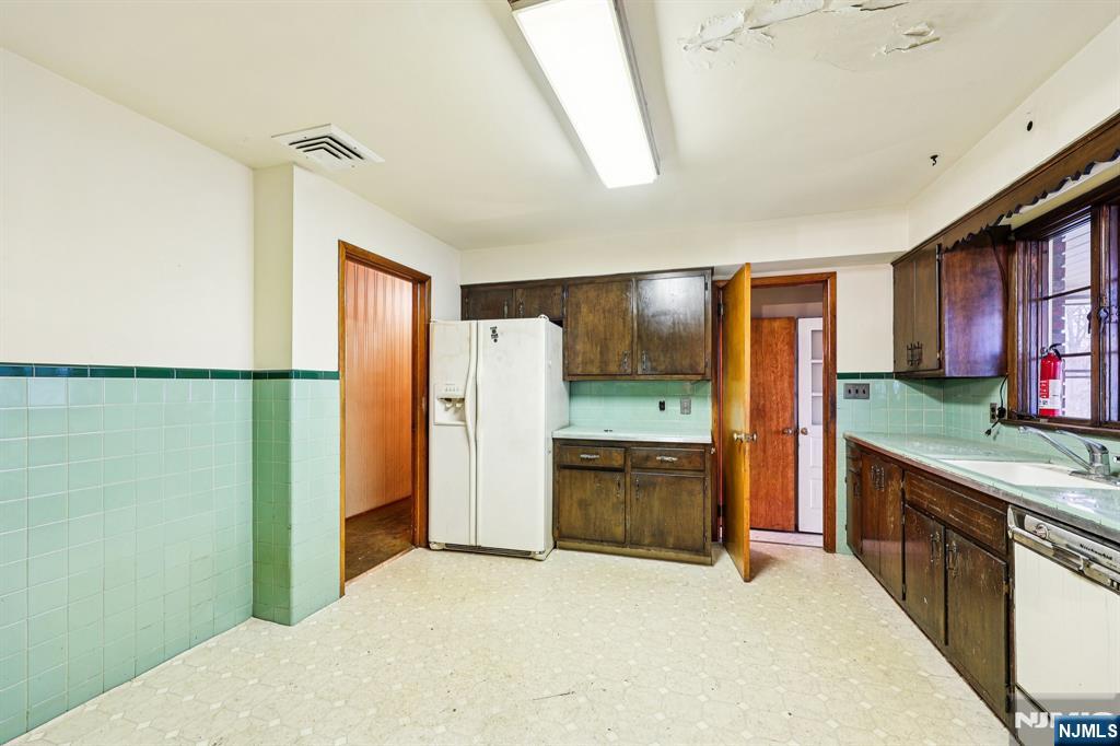 84 Squaw Brook Road North Haledon, NJ 07508 - Photo 7 of 23 a kitchen with stainless steel appliances granite countertop a refrigerator a stove and a sink