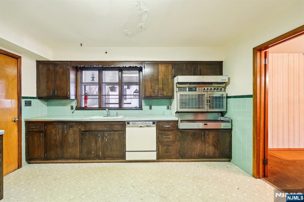 84 Squaw Brook Road North Haledon, NJ 07508 - Photo 8 of 23 a kitchen with stainless steel appliances granite countertop a stove and a sink