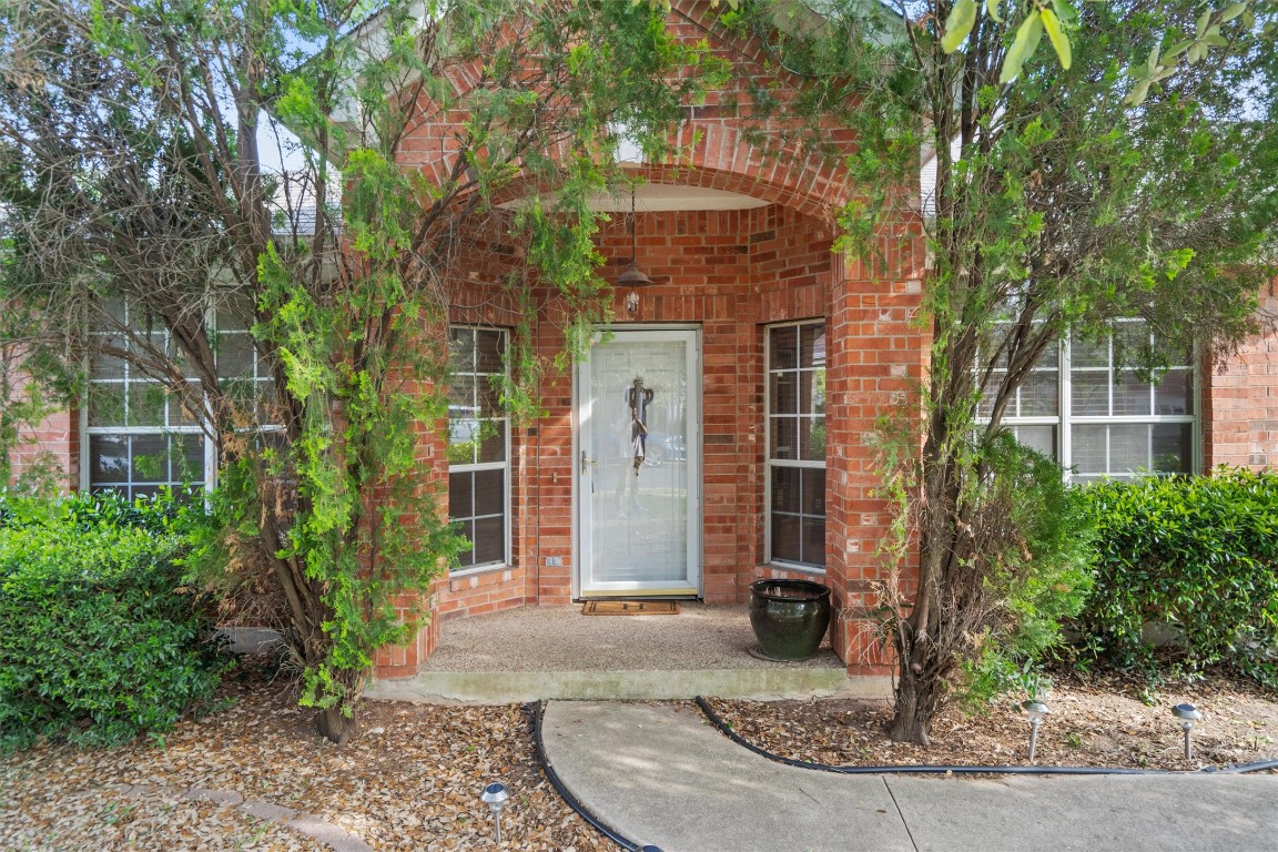 a front view of a house with a plants
