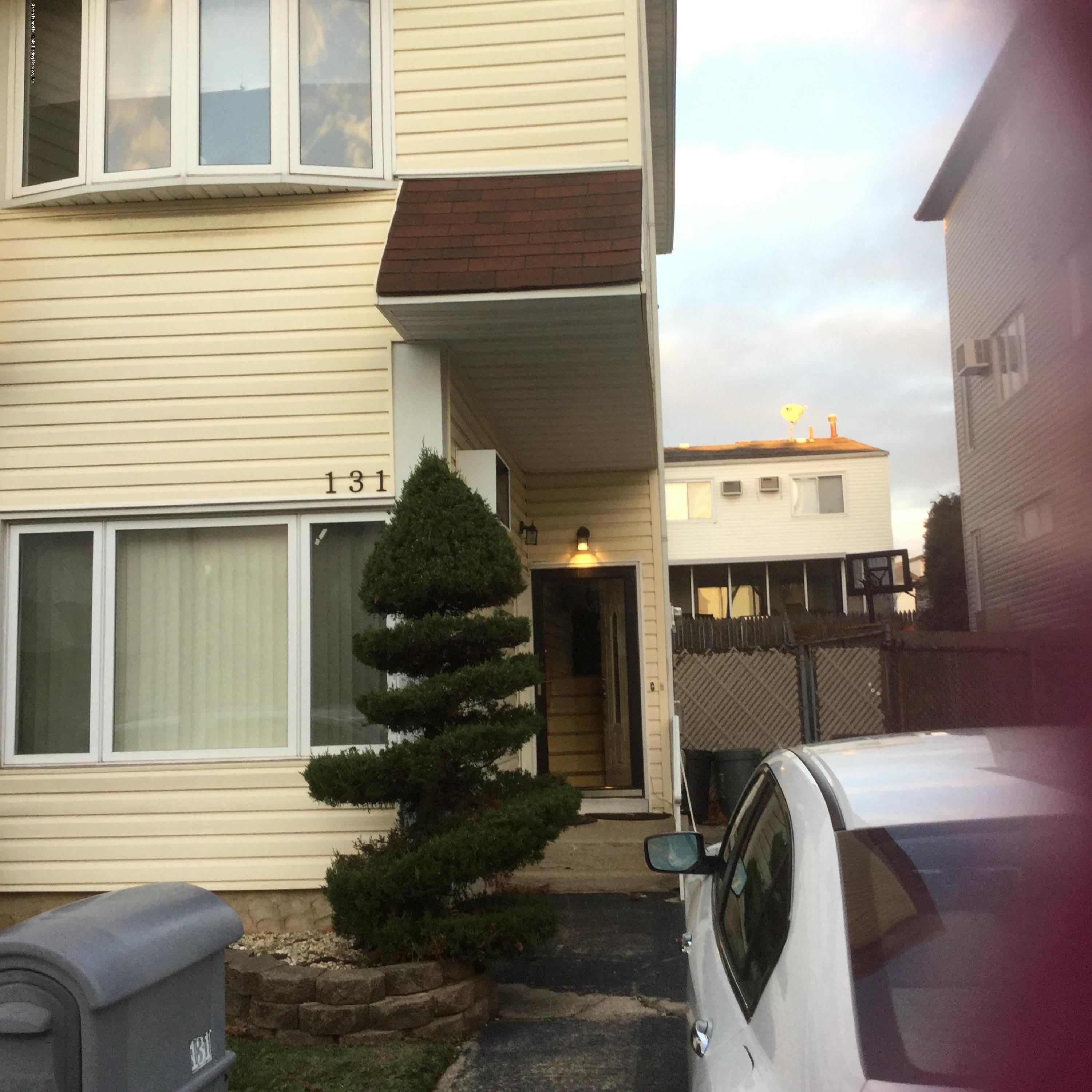 131 Green Valley Road Staten Island, NY 10312 - Photo 1 of 3 a front view of a house with outdoor space