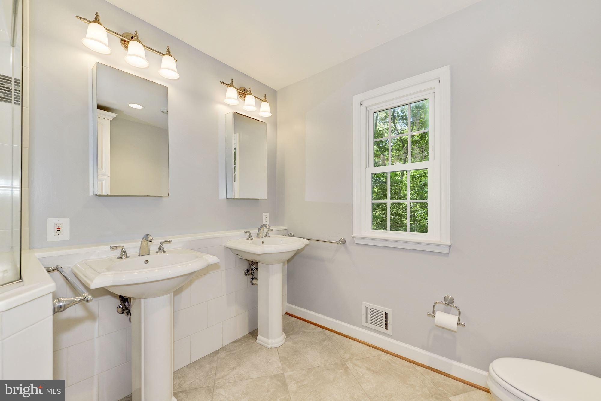 11603 Clipstone Lane Reston, VA 20191 - Photo 16 of 30 a bathroom with a sink toilet and a mirror