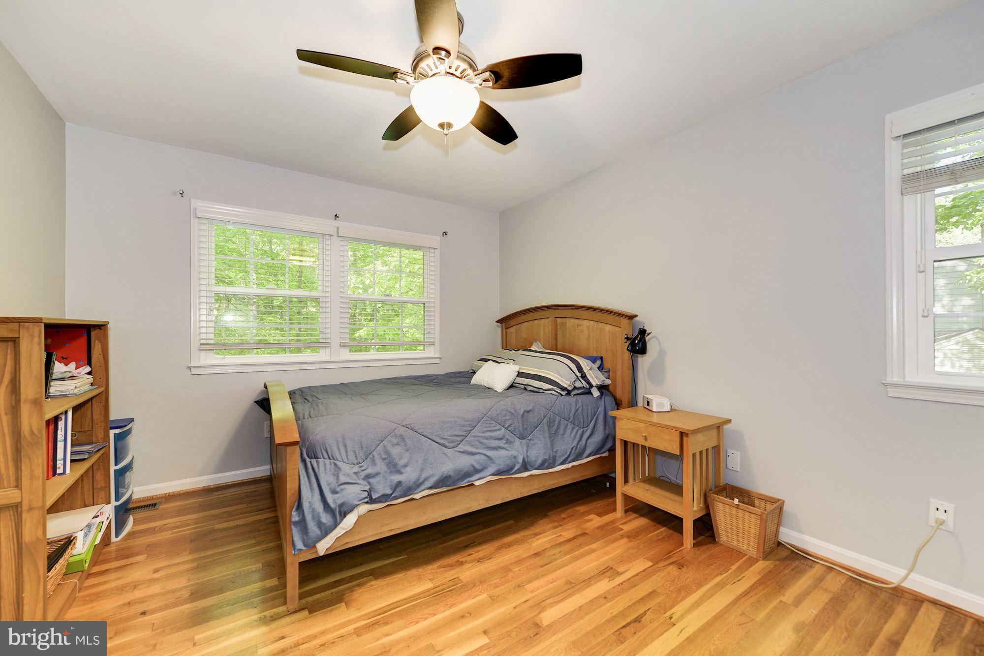 11603 Clipstone Lane Reston, VA 20191 - Photo 20 of 30 a bedroom with a bed and a chandelier