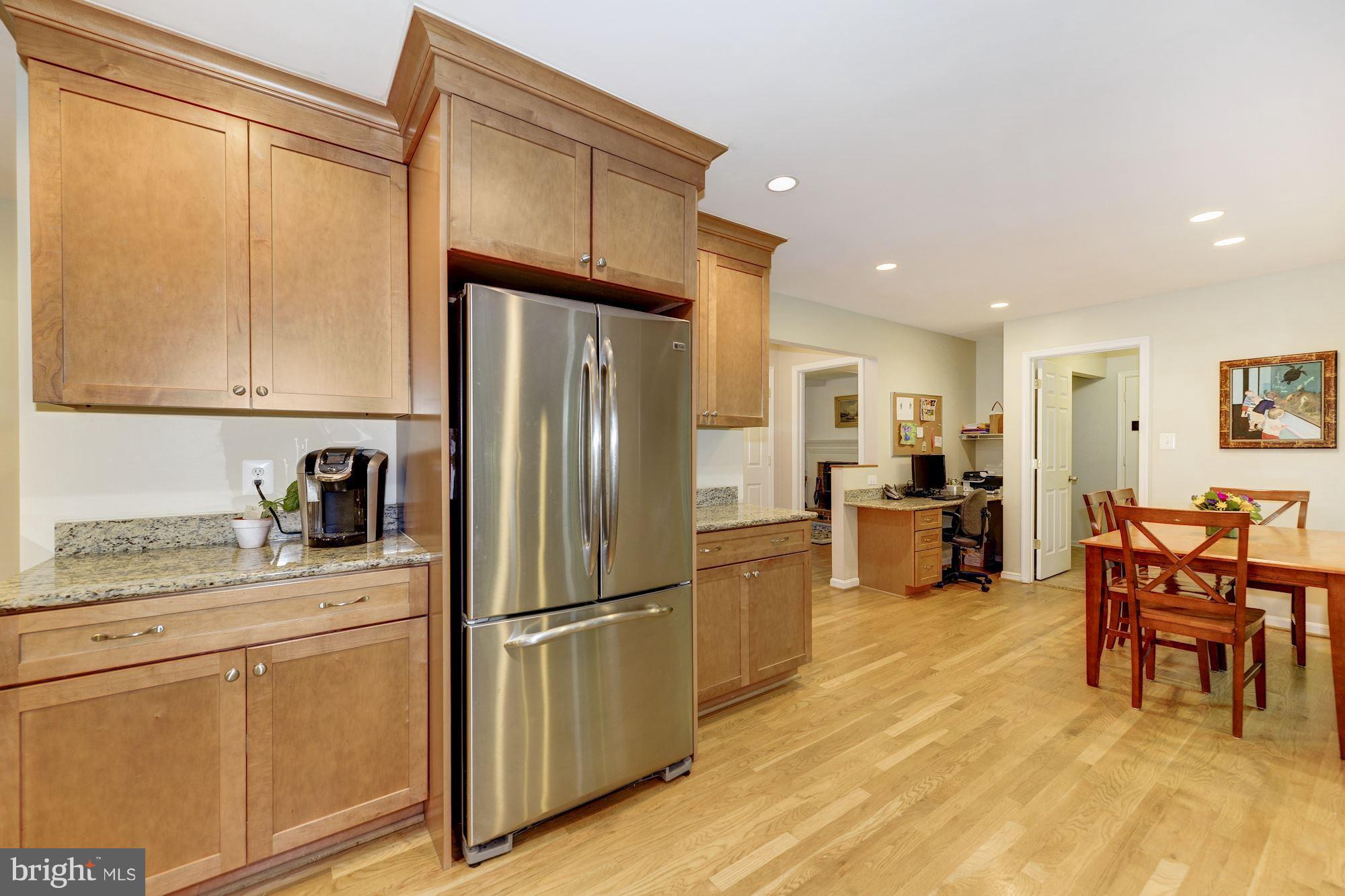 11603 Clipstone Lane Reston, VA 20191 - Photo 7 of 30 a kitchen with stainless steel appliances granite countertop a refrigerator and a sink