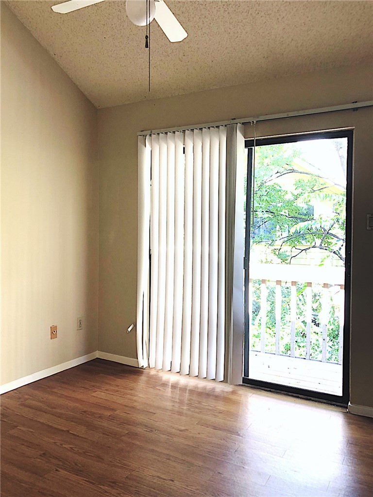 2210 Pearl Street, Unit 304 Austin, TX 78705 - Photo 13 of 18 a view of an empty room with wooden floor and a window