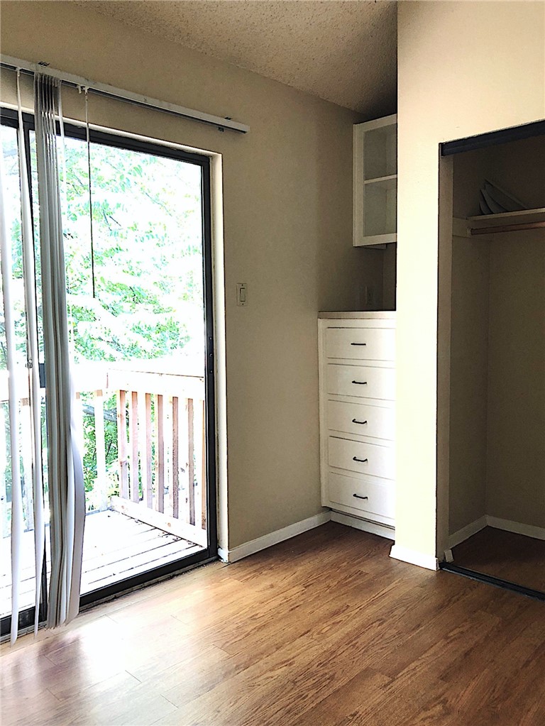 2210 Pearl Street, Unit 304 Austin, TX 78705 - Photo 14 of 18 a view of walk in closet with wooden floor