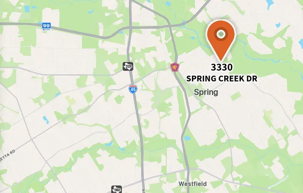 an aerial view of a residential apartment building with a yard