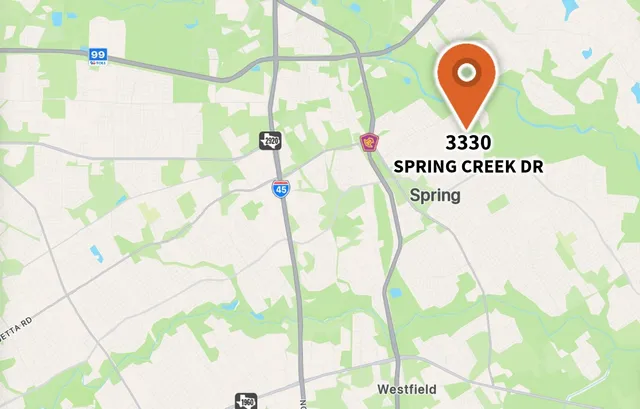 an aerial view of a residential apartment building with a yard