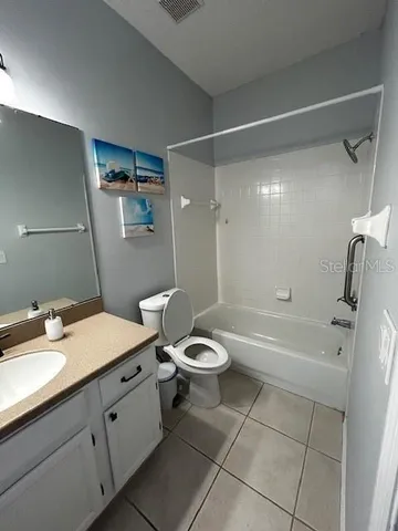 a bathroom with a granite countertop sink toilet a mirror and shower