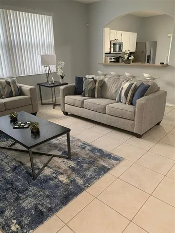 a living room with furniture and a rug