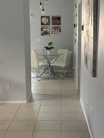 a dining room filled with furniture and a window