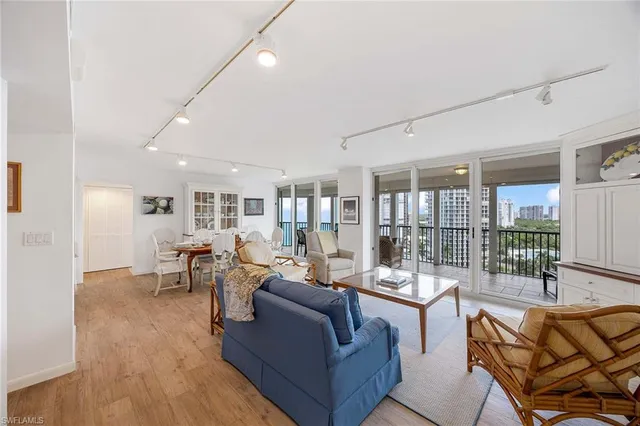a living room with furniture and view of kitchen