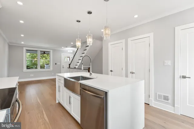 a kitchen with a sink a stove and cabinets
