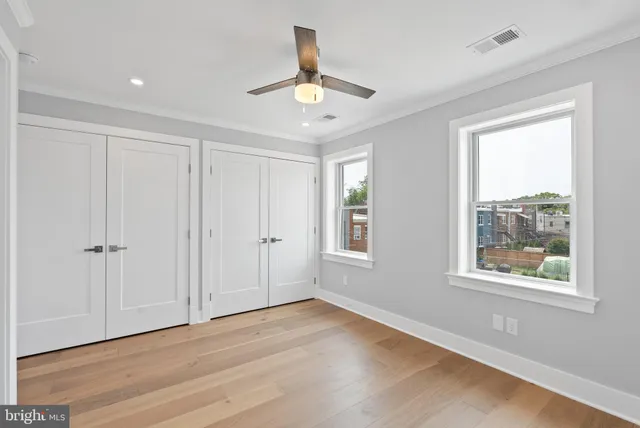 a bathroom with a granite countertop toilet a sink and mirror