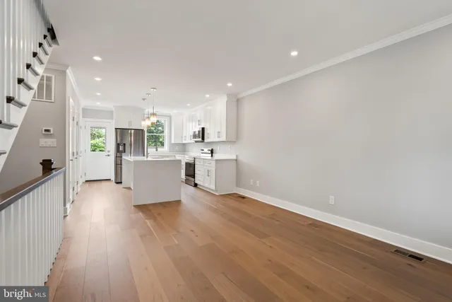 a view of kitchen with furniture and wooden floor