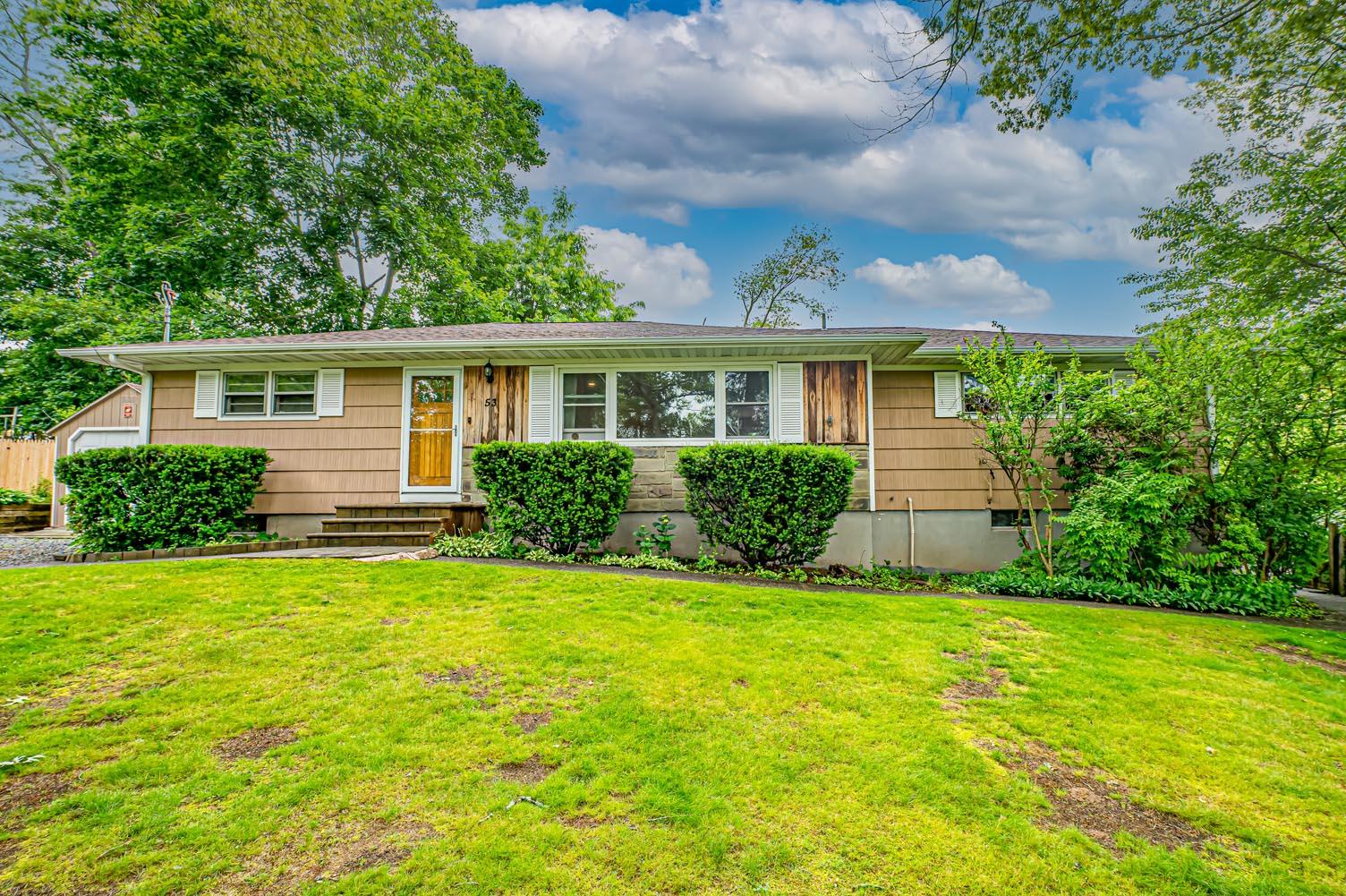 a view of garden with a house in the background