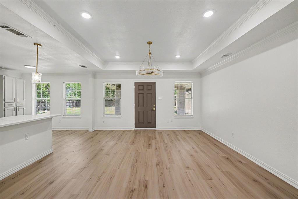 307 Dixon Street Terrell, TX 75160 - Photo 12 of 32 Expansive living area with wood-finish flooring, a tray ceiling, and recessed lighting