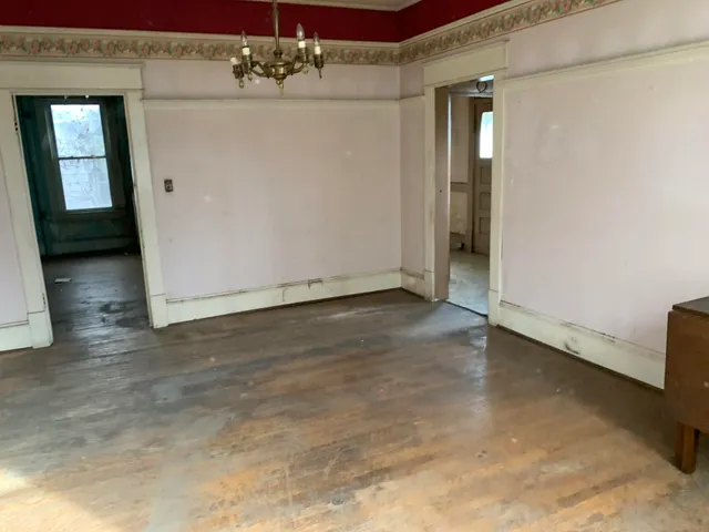 a view of a livingroom with wooden floor and cabinet
