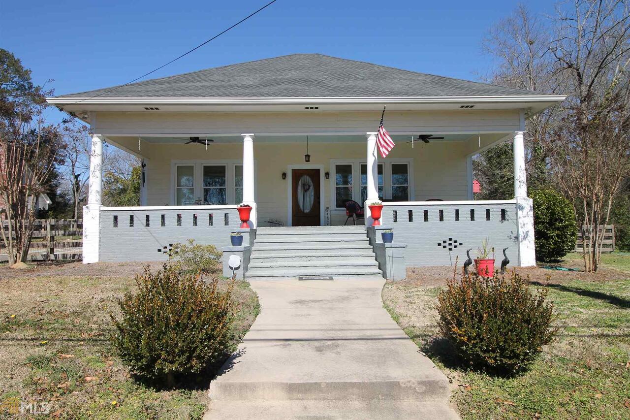 134 West Main Street Rutledge, GA 30663 - Photo 1 of 1 a view of a house with potted plants and a table