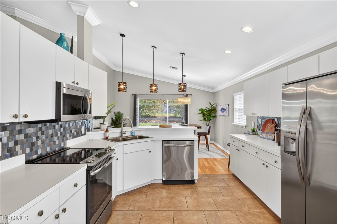 17974 Oakmont Ridge Circle Fort Myers, FL 33967 - Photo 11 of 35 a kitchen with stainless steel appliances a sink stove and cabinets