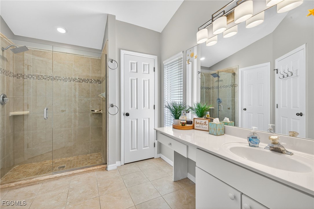 17974 Oakmont Ridge Circle Fort Myers, FL 33967 - Photo 18 of 35 a bathroom with a double vanity sink mirror and shower