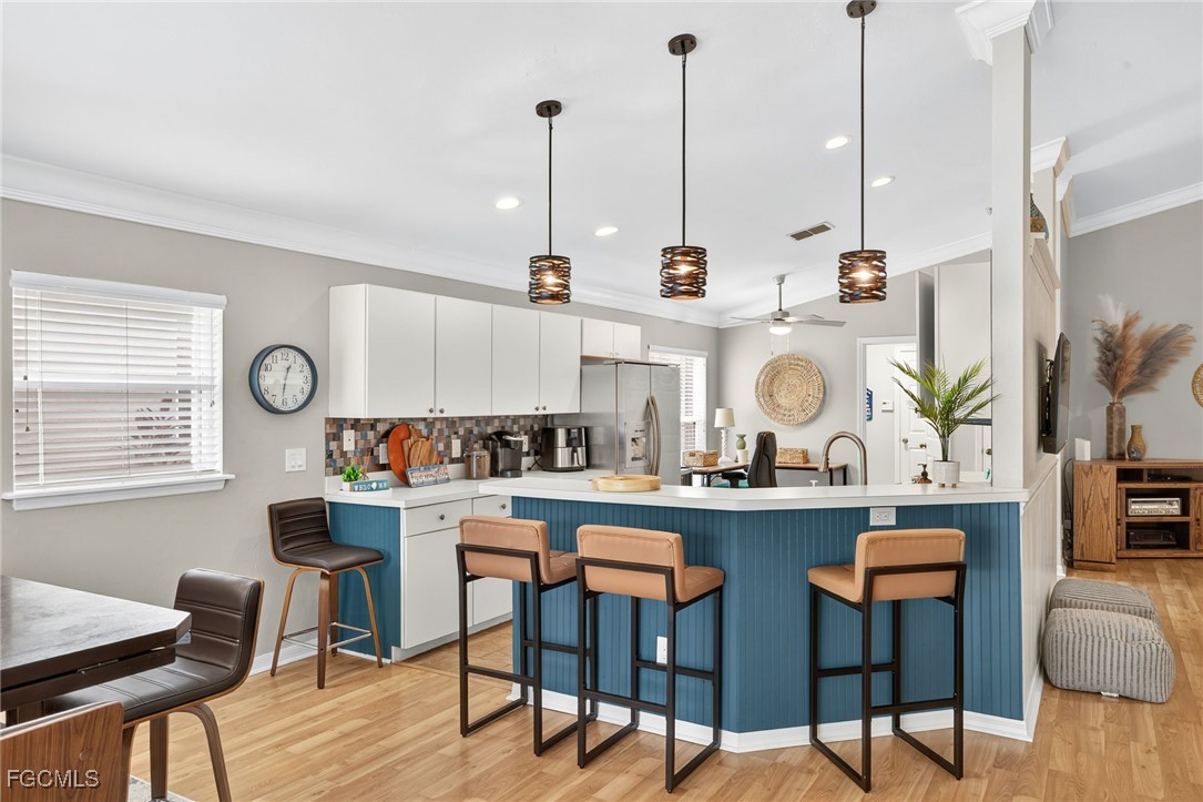 17974 Oakmont Ridge Circle Fort Myers, FL 33967 - Photo 9 of 35 a table with chairs and cabinets