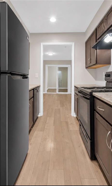 1166 Booth Road, Unit 407 Marietta, GA 30008 - Photo 5 of 18 a kitchen with granite countertop a stove and a refrigerator