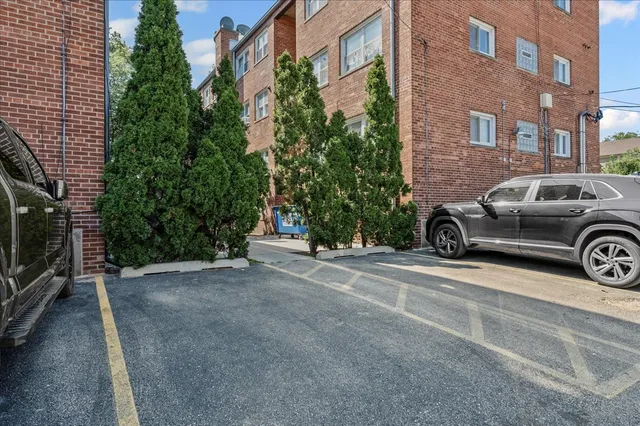 a view of a car parked in front of a building