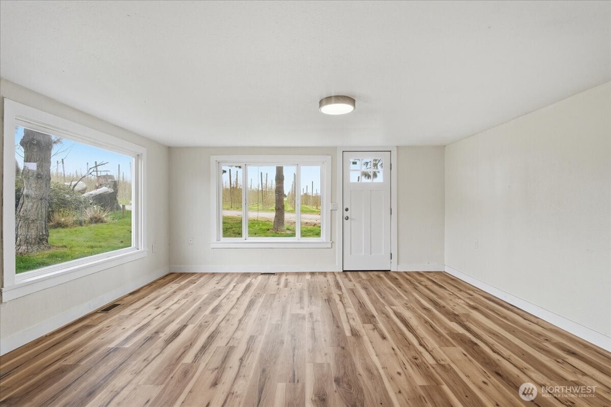 293 Barkley Road Manson, WA 98831 - Photo 4 of 40 wooden floor in an empty room with a window