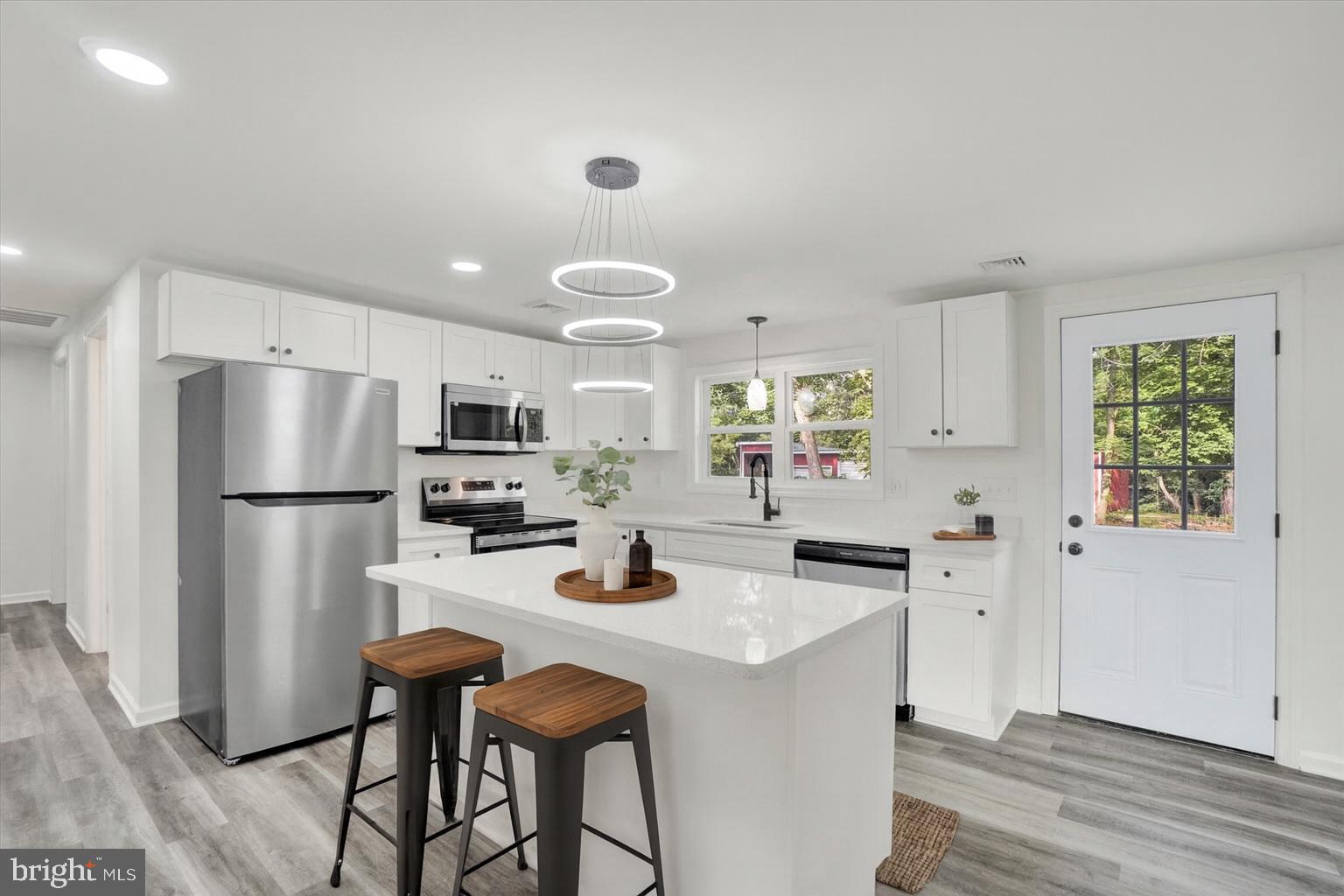 761 2nd Avenue Manchester, PA 17345 - Photo 1 of 29 a kitchen with a refrigerator a stove a sink and dishwasher with wooden floor